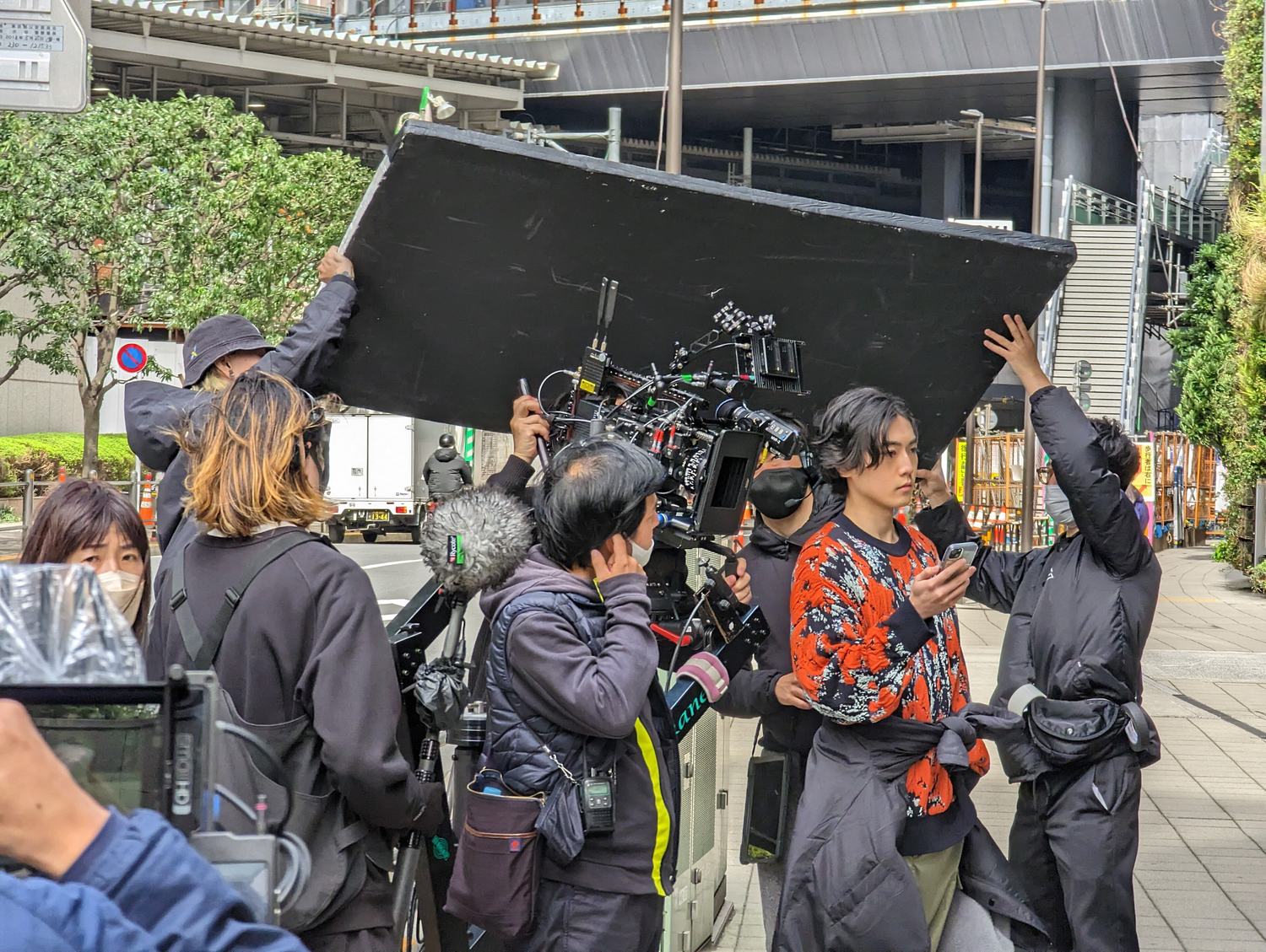 A film crew at work on location with lights and cameras