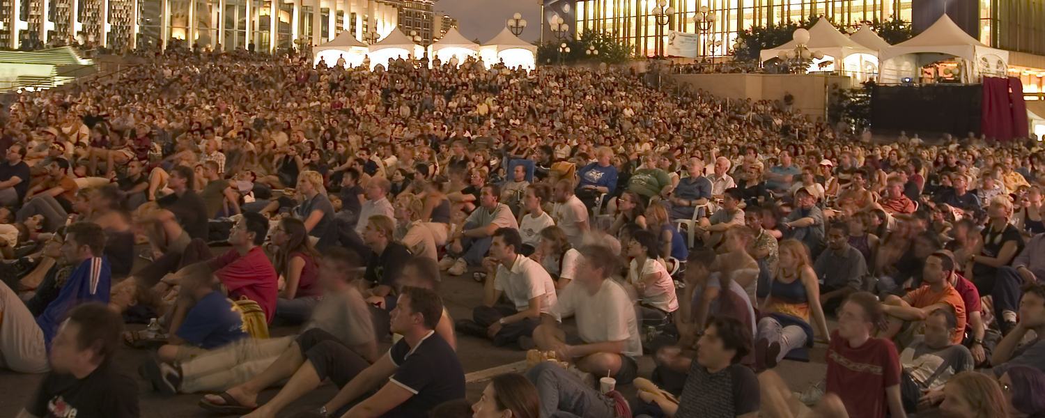 A large evening crowd gathered for an open-air event